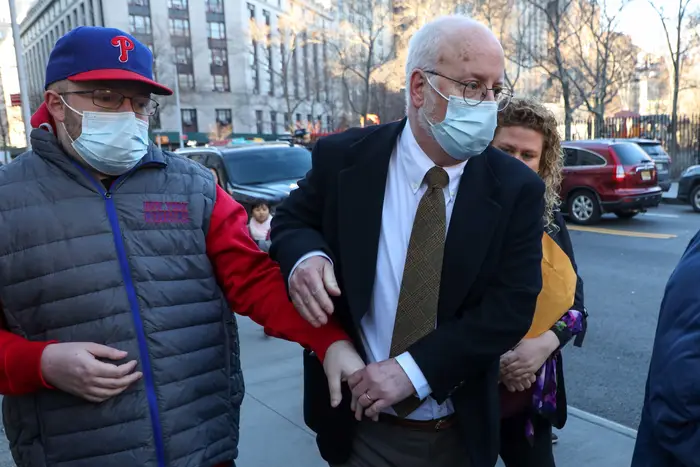 A man wearing a mask is pictured leaving the courthouse.